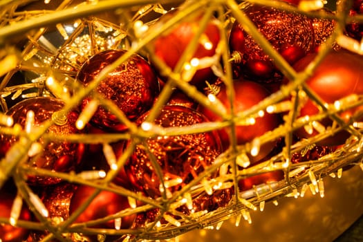 Close up of red Christmas balls baubles. Bokeh garlands. Xmas and holidays concept. Copy space and empty place for text, mock up greeting card.