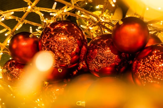 Close up of red Christmas balls baubles. Bokeh garlands. Xmas and holidays concept. Copy space and empty place for text, mock up greeting card.