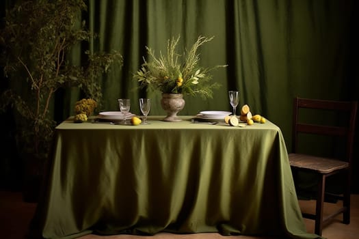 Table set with a green tablecloth, glassware, and a floral centerpiece. It has a dark and elegant mood.