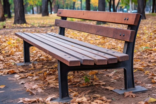 A photo of a bench in a park with tree and grass, bench in a garden on a sunny day outside