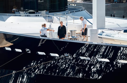 Monaco, Monte Carlo, 28 September 2022 - Invited wealthy clients inspect megayachts at the largest fair exhibition in the world yacht show MYS, port Hercules, yacht brokers, sunny weather. High quality photo