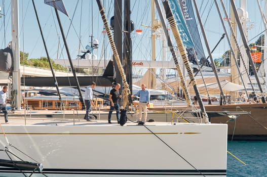 Monaco, Monte Carlo, 28 September 2022 - Invited wealthy clients inspect megayachts at the largest fair exhibition in the world yacht show MYS, port Hercules, yacht brokers, sunny weather. High quality photo