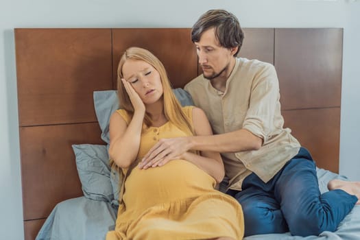 Expectant woman feels unwell, husband comforts and reassures her during a challenging pregnancy.