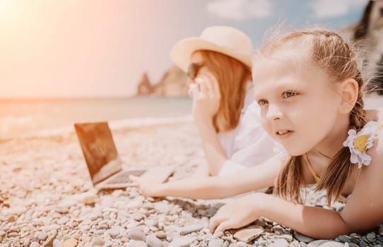 Woman sea laptop. Business woman in yellow hat working on laptop by sea. Close up on hands of pretty lady typing on computer outdoors summer day. Freelance, digital nomad, travel and holidays concept.