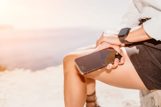 Happy girl doing yoga with laptop working at the beach. beautiful and calm business woman sitting with a laptop in a summer cafe in the lotus position meditating and relaxing. freelance girl remote work beach paradise