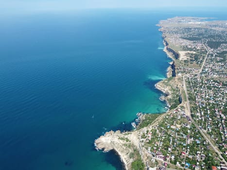 Aerial panoramic view of beautiful sunset above sea. Beautiful seascape. Sun glare, small waves on the water surface. Evening. Horizon. Nobody. No people. Copy space. Never-ending beauty of nature