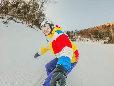 A daring man conquers snowy slopes with style, showcasing skill and thrill as he maneuvers on a snowboard, capturing the essence of winter adventure.