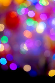 Festive flashing abstract background. Blurred texture background with round bokeh spots. Multicolored blinks background. Celebration New Year Christmas Birthday party holiday Flickering illumination