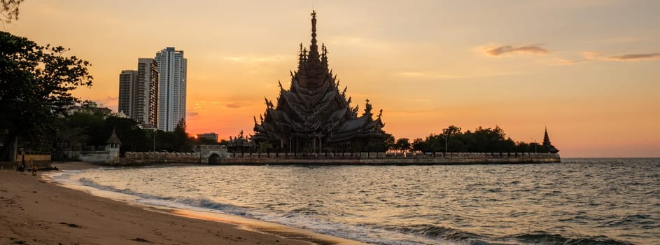 The Sanctuary of Truth wooden temple in Pattaya Thailand is a gigantic wooden construction located at the cape of Naklua Pattaya City Chonburi Thailand at sunset from the beach