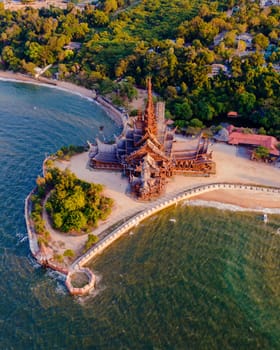 The Sanctuary of Truth wooden temple in Pattaya Thailand in the evening light, wooden temple of Pattaya in the warm light of sunset by the ocean