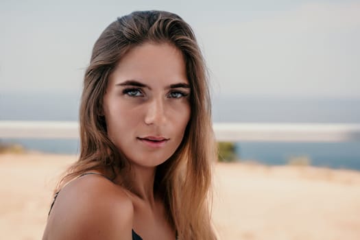 Happy woman portrait in cafe. Boho chic fashion style. Outdoor photo of young happy woman with long hair, sunny weather outdoors sitting in modern cafe