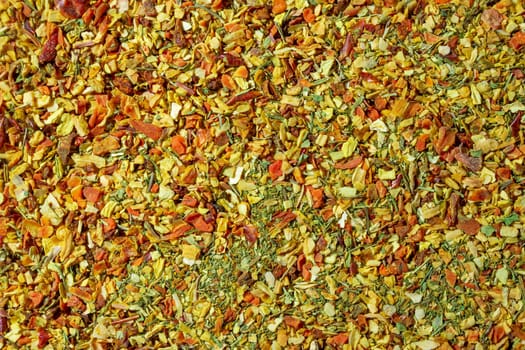 Vibrant and Colored Vegetable Seasoning Mix: A Culinary Canvas of Aromatic Seasoning - Textured Background for Gourmet Cooking. The Harmonious Combination of Fresh Herbs and Spices - Top View