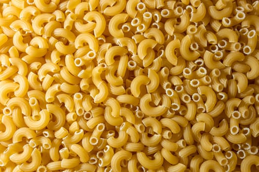 Uncooked Chifferi Rigati Pasta: A Culinary Canvas of Chifferi Rigati, Creating a Lively and Textured Background for Gourmet Cooking. Dry Pasta. Raw Macaroni - Top View, Flat Lay