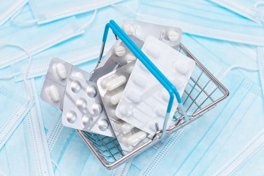 Buying Medicines. Expensive Medicine and Inflation Concept: Pills and Capsules in Shopping Basket on the Surgical Masks. Global Pharmaceutical Industry and Big Pharma. Ordering Pharmaceutical Products