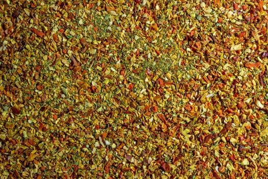 Vibrant and Colored Vegetable Seasoning Mix: A Culinary Canvas of Aromatic Seasoning - Textured Background for Gourmet Cooking. The Harmonious Combination of Fresh Herbs and Spices - Top View