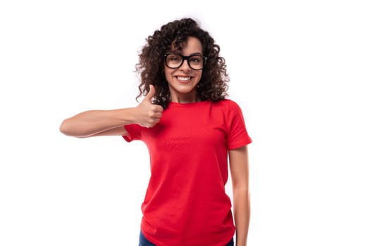 caucasian young energetic curly brunette woman in red casual t-shirt.