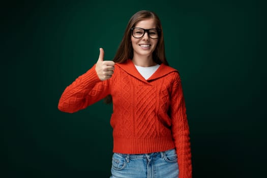 Smart Caucasian woman with brown straight hair and glasses on green background.