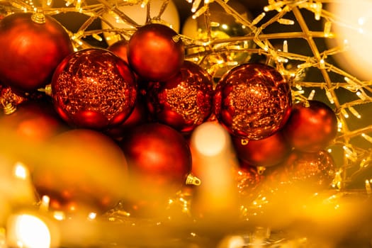 Red glowing Christmas balls garlands close-up. Holidays decoration and festive xmas concept. Copy space and empty place for text, mock up greeting card.