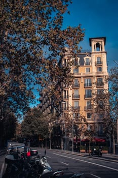 Old apartment building near road. Beautiful urban scenery photography. Road traffic. Barcelona street scene. High quality picture for wallpaper, article