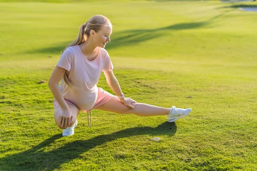 Energetic pregnant woman takes her workout outdoors, using an exercise mat for a refreshing and health-conscious outdoor exercise session.