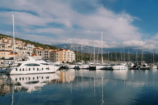 Yachts are moored at the Lustica Bay marina at the foot of the mountains. Montenegro. High quality photo