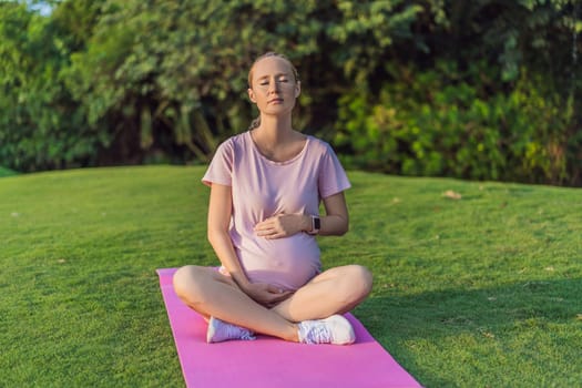 Energetic pregnant woman takes her workout outdoors, using an exercise mat for a refreshing and health-conscious outdoor exercise session.