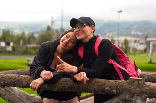 mother's love and daughter's love. daughter with her head resting on her mother's shoulder showing her eternal love as a woman. women's day. High quality photo