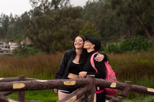 mother proud of her daughter for going from girl to woman, on a wooden bridge the two are happy living a moment between women of true love. women's day. High quality photo