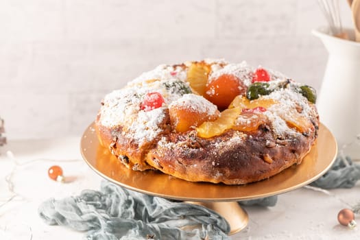 Bolo do Rei or King's Cake, Made for Christmas, Carnavale or Mardi Gras with Christmas season elements in Background.