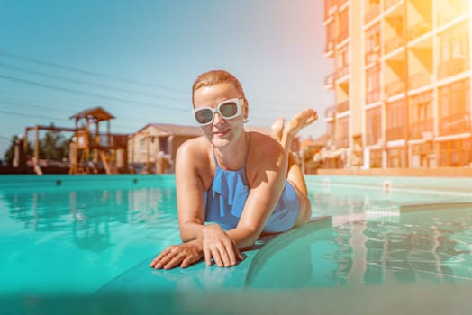 Bikini-clad woman enjoys poolside relaxation. Poolside ambiance. Capturing woman's relaxed time near pool