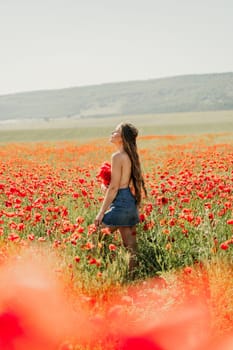 Woman poppies field. portrait of a happy woman with long hair in a poppy field and enjoying the beauty of nature in a warm summer day