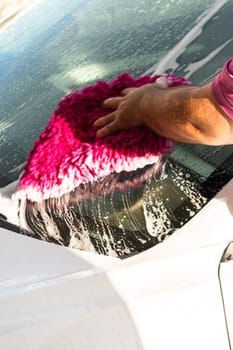 Efficiently cleaning an electric car in the comfort of a suburban driveway, combining eco-consciousness with practicality.