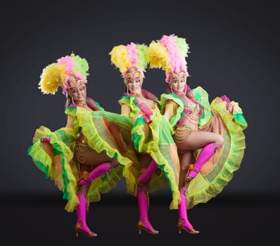 Fascinating female dancers in colorful carnival costumes