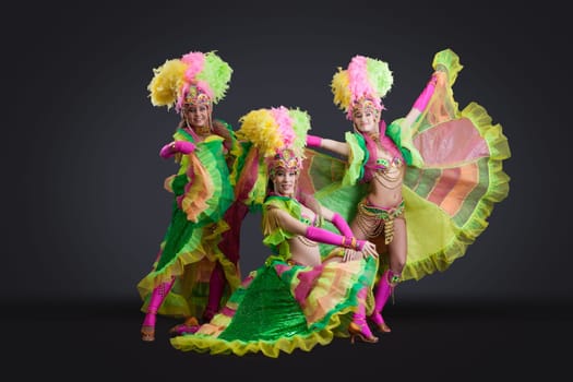 Beautiful dancers posing in colorful carnival costumes