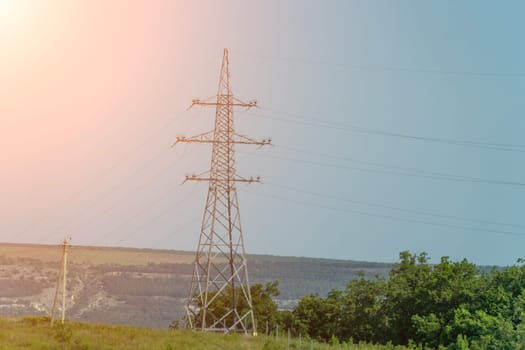 High voltage towers with sky background. Power line support with wires for electricity transmission. High voltage grid tower with wire cable at distribution station. Energy industry, energy saving.