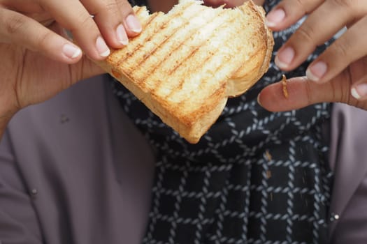 women eating toasted Sandwich with ham and cheese,.