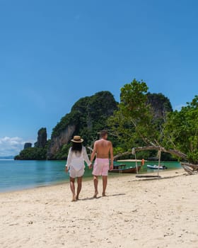 Koh Phakbia Island is near Koh Hong Krabi, a beautiful white sandy beach in Krabi Thailand. Young Asian women and European men on the beach during a vacation in Thailand.