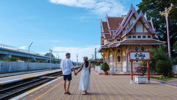 Hua Hin train station in Thailand. passengers waiting for the train in Huahin. a couple of men and woman waiting for the train at an empty train station