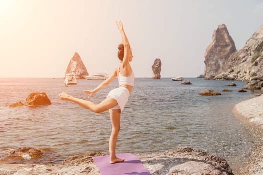 Fitness woman sea. Outdoor workout on yoga mat in park near to ocean beach. Female fitness pilates yoga routine concept. Healthy lifestyle. Happy fit woman exercising with rubber band in park.