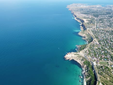 Aerial panoramic view of beautiful sunset above sea. Beautiful seascape. Sun glare, small waves on the water surface. Evening. Horizon. Nobody. No people. Copy space. Never-ending beauty of nature