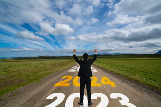 2024 New Year journey and future vision concept . Businessman traveling on highway road leading forward to happy new year celebration in beginning of 2024 for bliss and successful start .