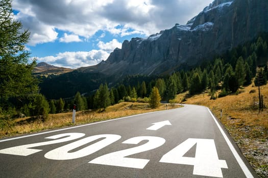 2024 New Year road trip travel and future vision concept . Nature landscape with highway road leading forward to happy new year celebration in the beginning of 2024 for bliss and successful start .