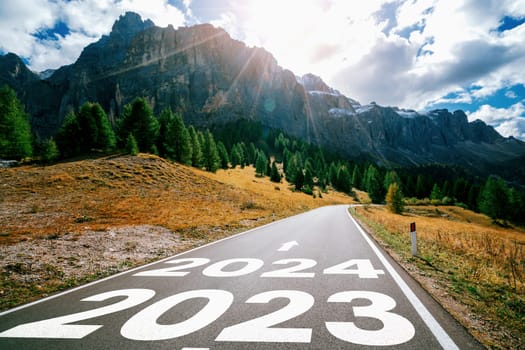 2024 New Year road trip travel and future vision concept . Nature landscape with highway road leading forward to happy new year celebration in the beginning of 2024 for bliss and successful start .