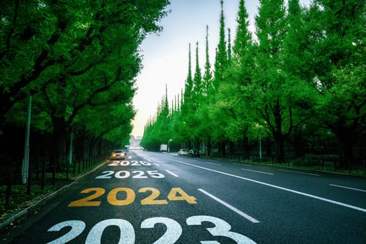 2024 New Year road trip travel and future vision concept . Nature landscape with highway road leading forward to happy new year celebration in the beginning of 2024 for bliss and successful start .