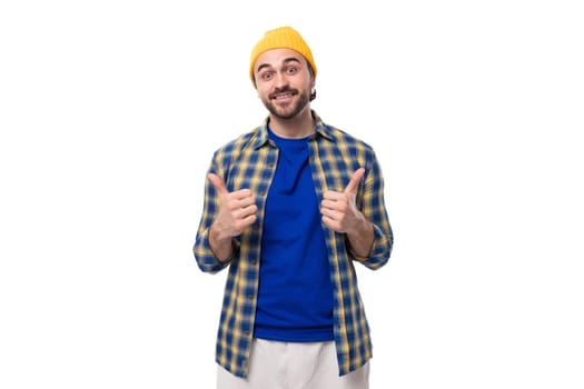cute charming young hipster man in yellow cap and shirt on white background with copy space.
