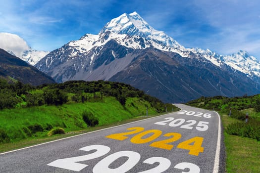 2024 New Year road trip travel and future vision concept . Nature landscape with highway road leading forward to happy new year celebration in the beginning of 2024 for bliss and successful start .