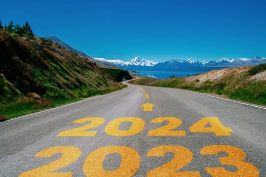 2024 New Year road trip travel and future vision concept . Nature landscape with highway road leading forward to happy new year celebration in the beginning of 2024 for bliss and successful start .