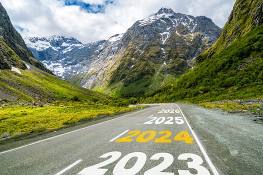 2024 New Year road trip travel and future vision concept . Nature landscape with highway road leading forward to happy new year celebration in the beginning of 2024 for bliss and successful start .