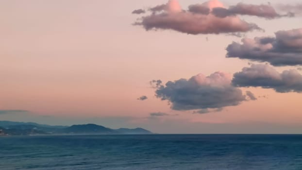 Background of pink clouds in evening sky over sea, twilight fairy sunset, copy space.