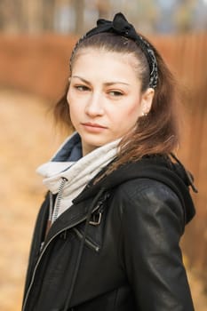 Outdoor atmospheric lifestyle portrait of young beautiful young woman copy space. Warm autumn fall season. Millennial generation and youth.